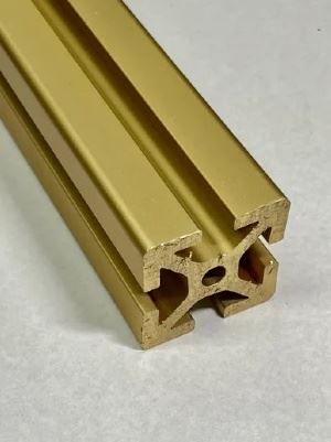A close up of a gold metal bar on a white surface.