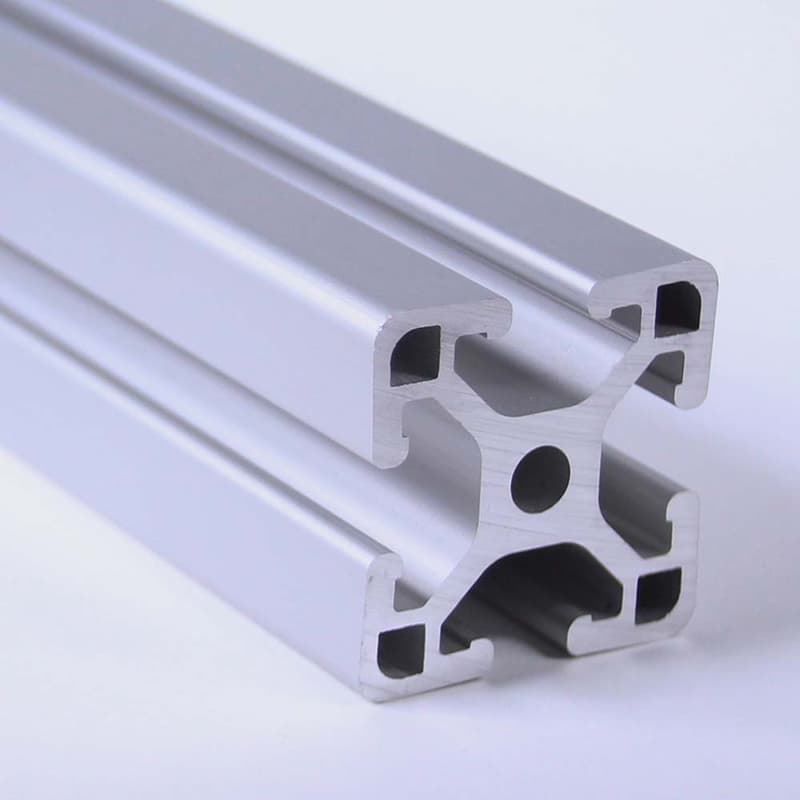 A piece of aluminum with holes in it on a white surface