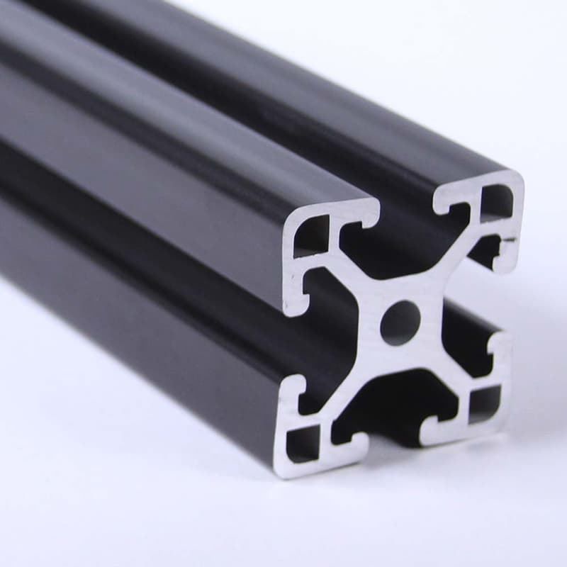 A close up of a black aluminum beam with a hole in the middle