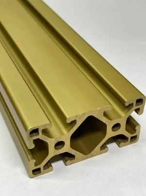 A close up of a gold colored aluminum beam on a white surface.