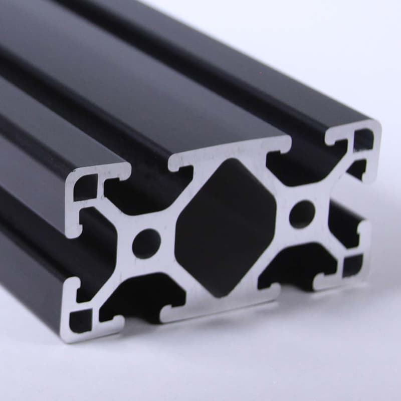 A close up of a black aluminum frame on a white surface