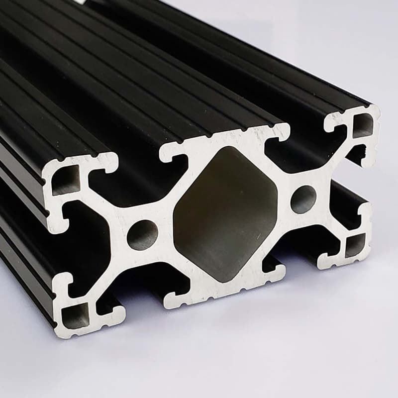 A close up of a black aluminum tube on a white surface