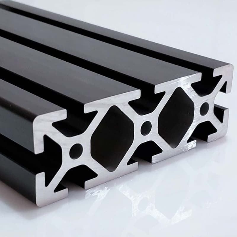 A close up of a black aluminum beam on a white surface