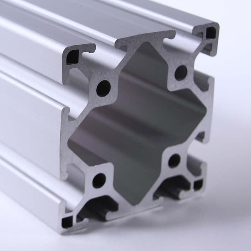 A close up of an aluminum beam on a white surface