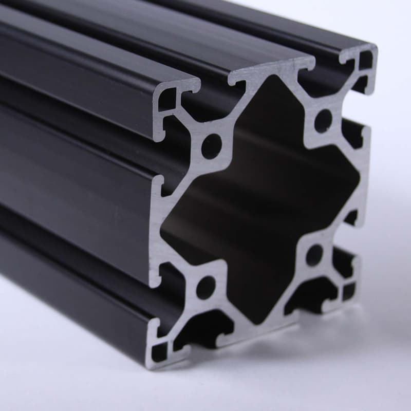 A close up of a black aluminum beam on a white surface