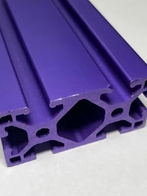A close up of a purple aluminum extrusion on a white surface.