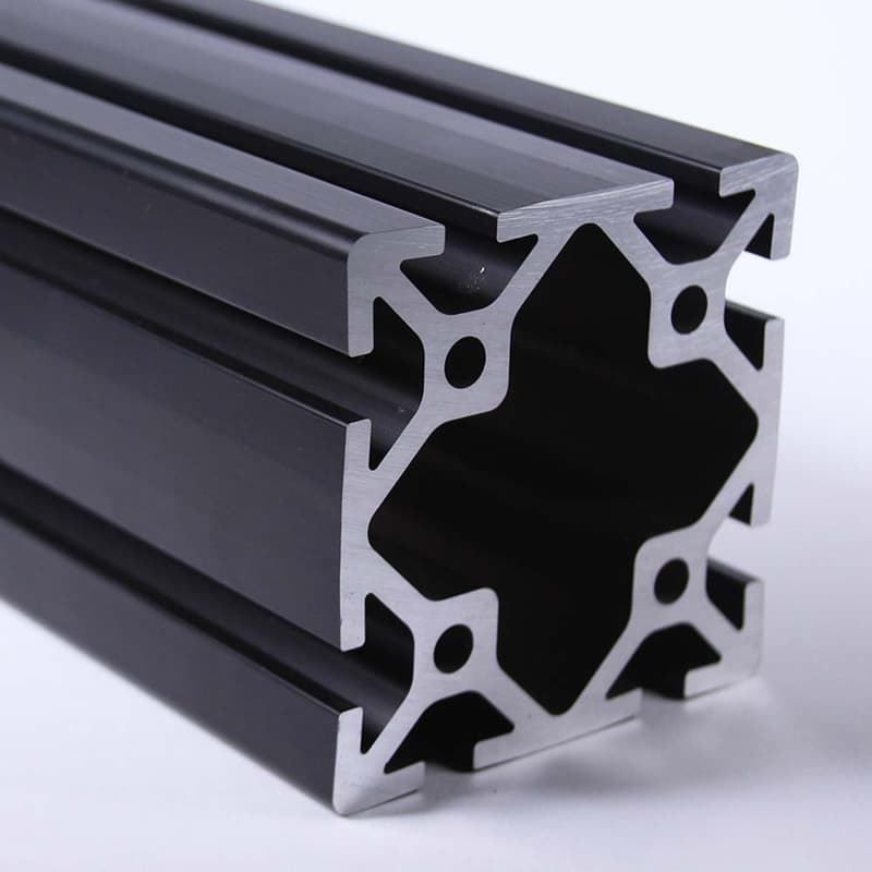A close up of a black aluminum beam on a white surface