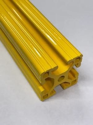 A yellow plastic pipe is sitting on a white surface.