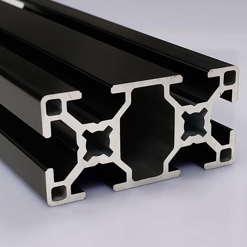 A close up of a black aluminum beam on a white surface