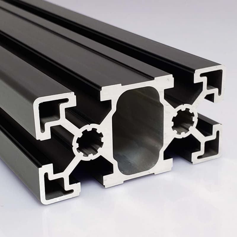 A close up of a black aluminum beam on a white surface