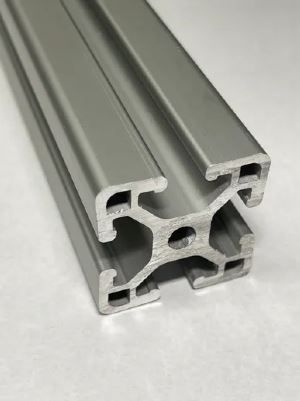 A close up of an aluminum extrusion on a white surface.