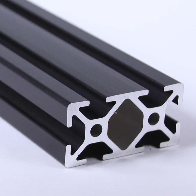A close up of a black aluminum beam on a white surface