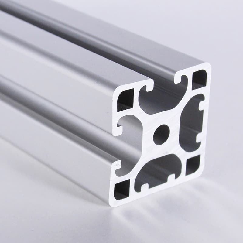 A close up of a piece of aluminum on a white surface