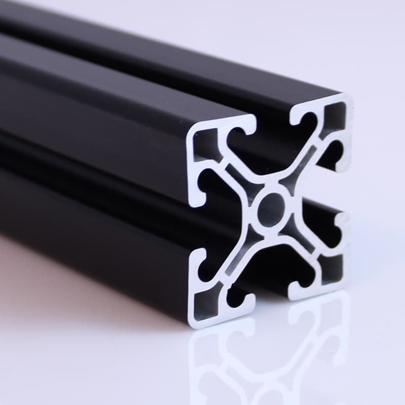 A close up of a black metal bar on a white surface