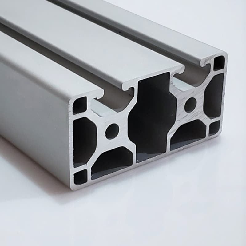 A close up of an aluminum beam on a white surface.