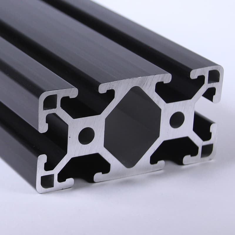 A close up of a black aluminum beam on a white surface