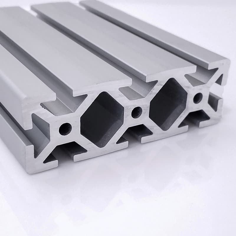 A close up of a piece of aluminum on a white surface