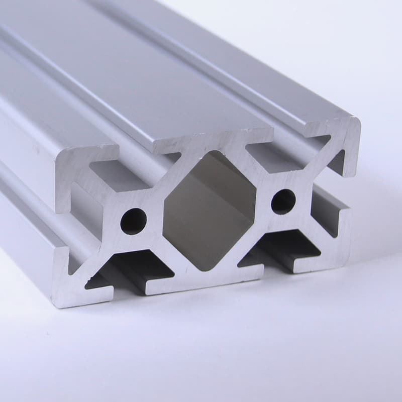 A piece of aluminum with holes in it on a white surface