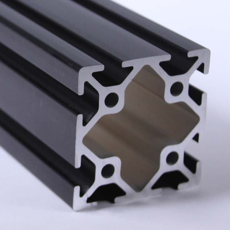 A close up of a black aluminum beam on a white surface