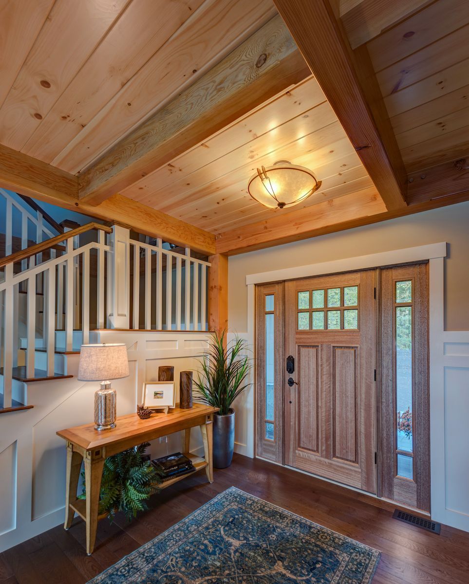 A hallway with a wooden door and stairs