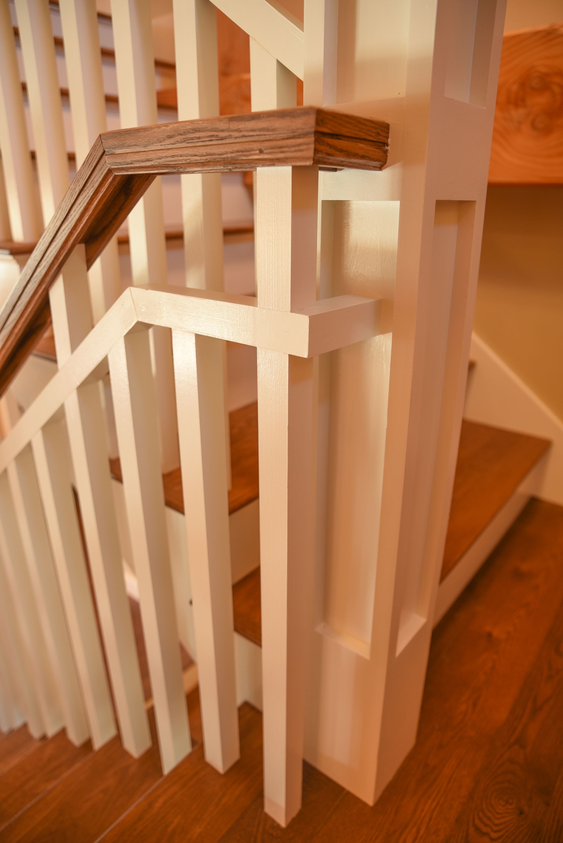 A staircase with a white railing and wooden steps