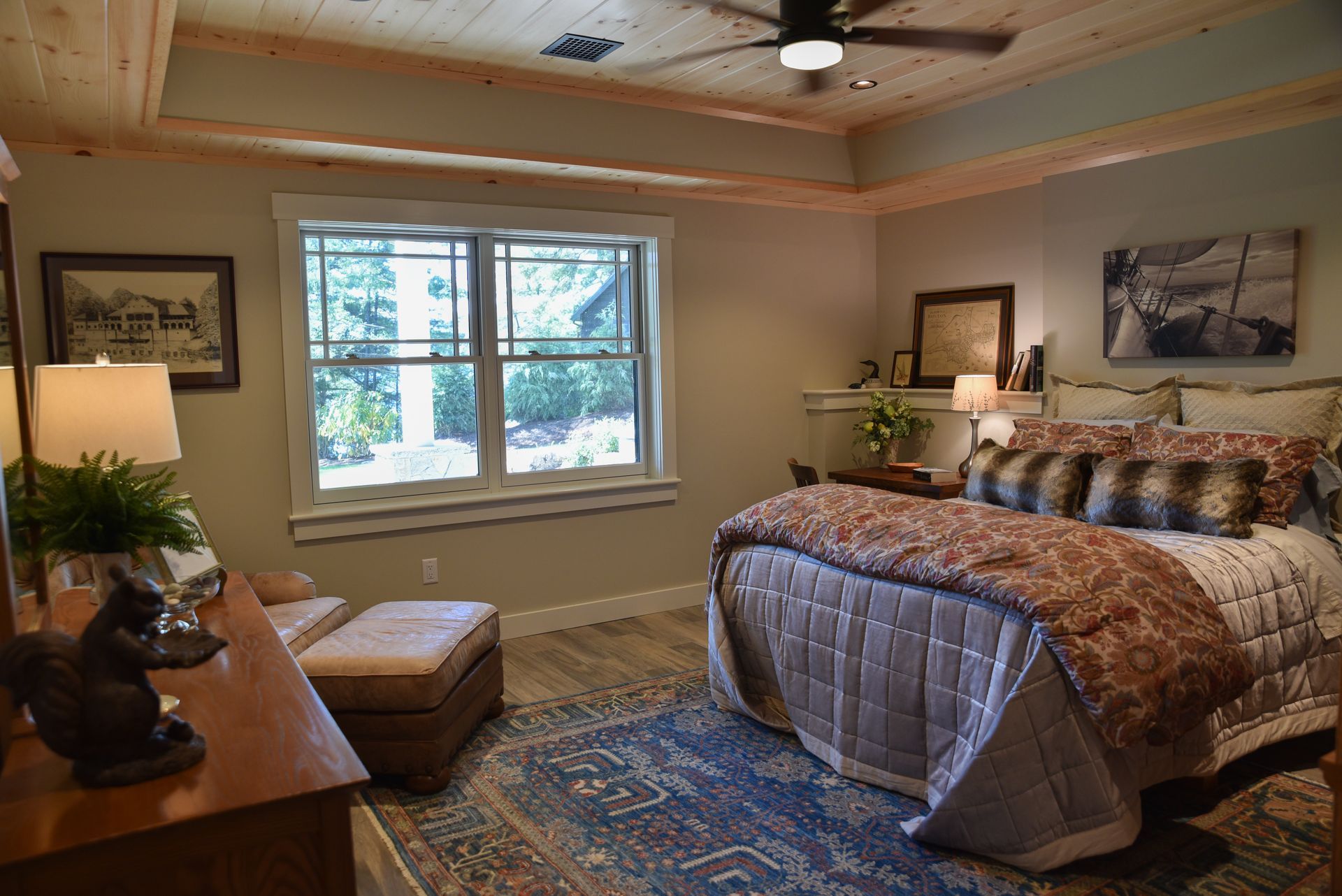 A bedroom with a large bed and a ceiling fan.