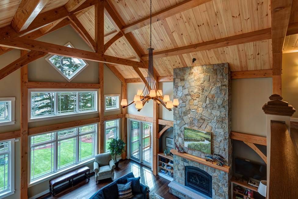An aerial view of a living room with a fireplace and lots of windows.