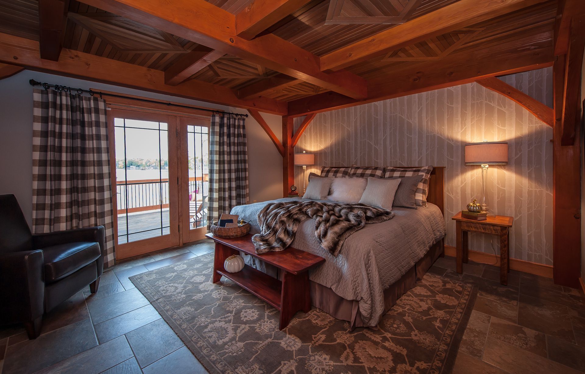 Cozy bedroom with plaid curtains, exposed wooden beams, and a bed with fur throw.