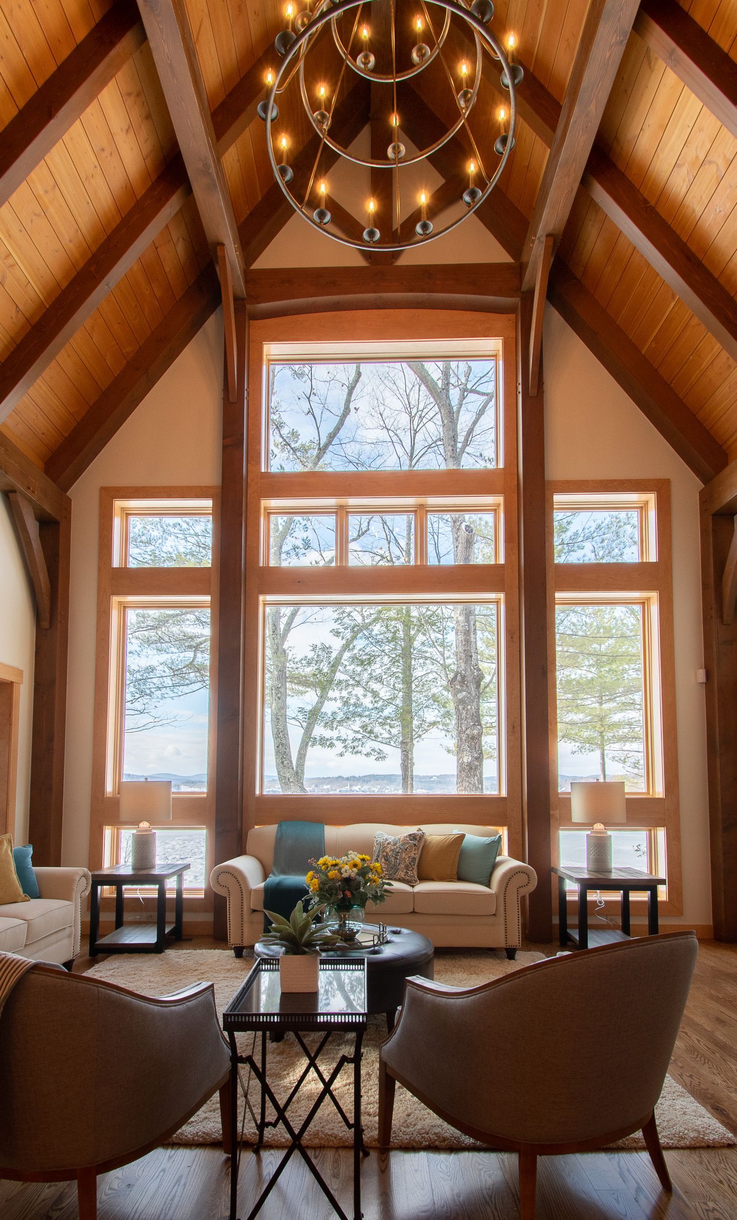 A living room with a lot of windows and a chandelier