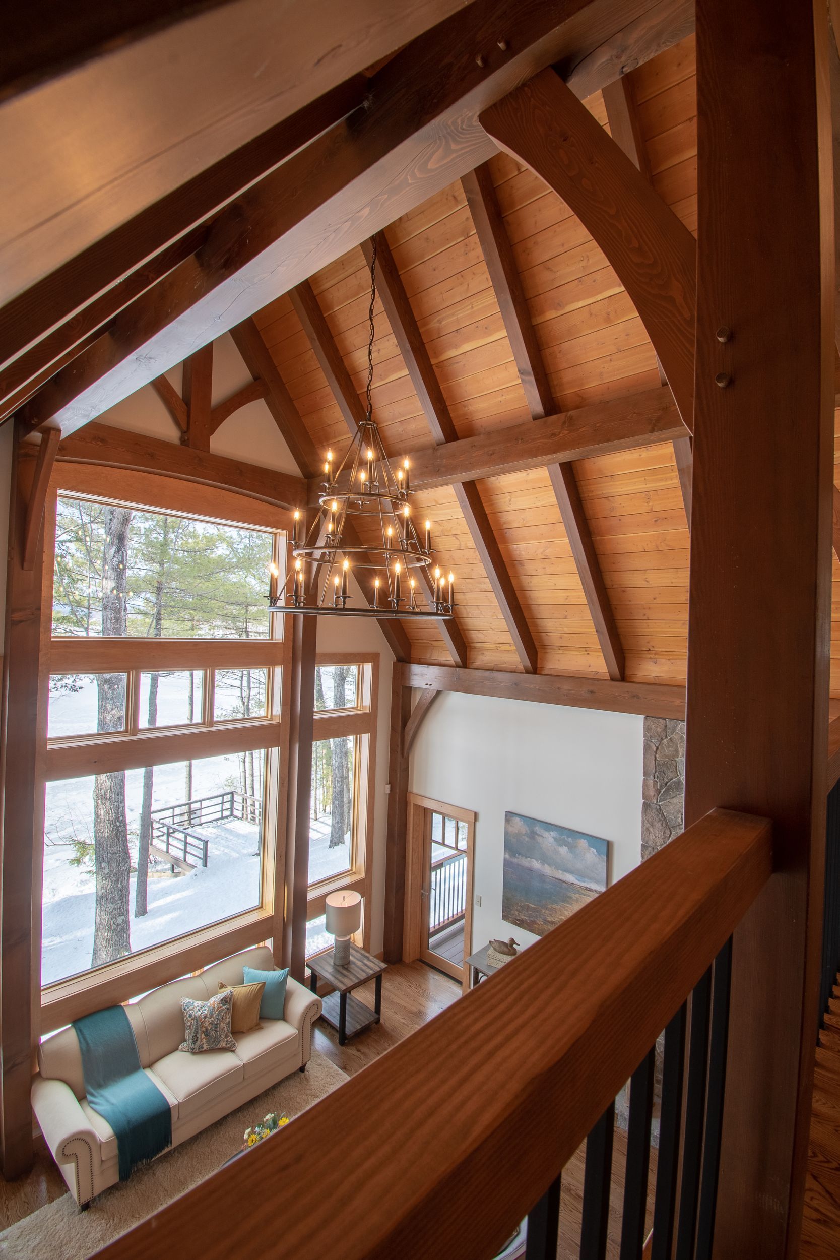 A living room with a couch and a chandelier hanging from the ceiling