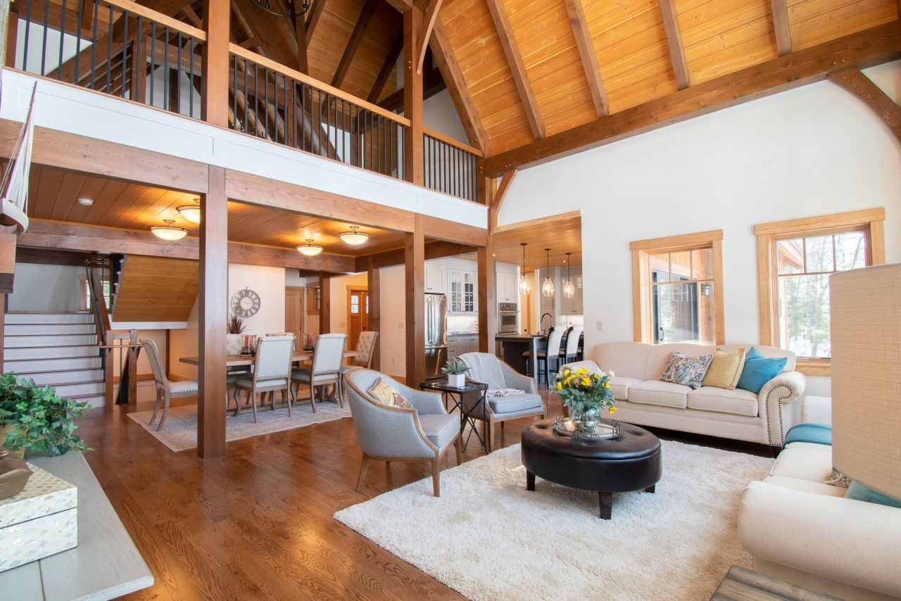 A living room filled with furniture and a vaulted ceiling.