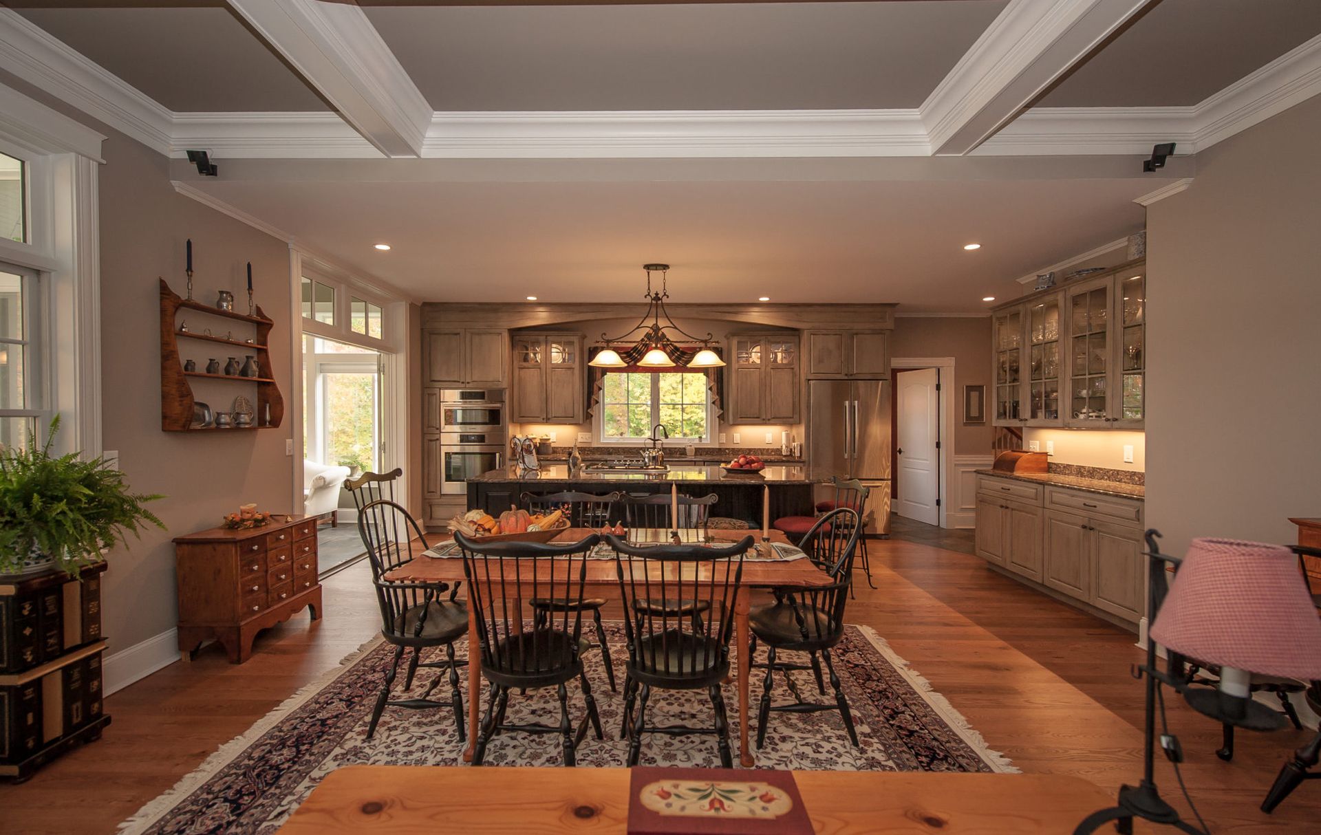 A kitchen and dining room in a house with a table and chairs.