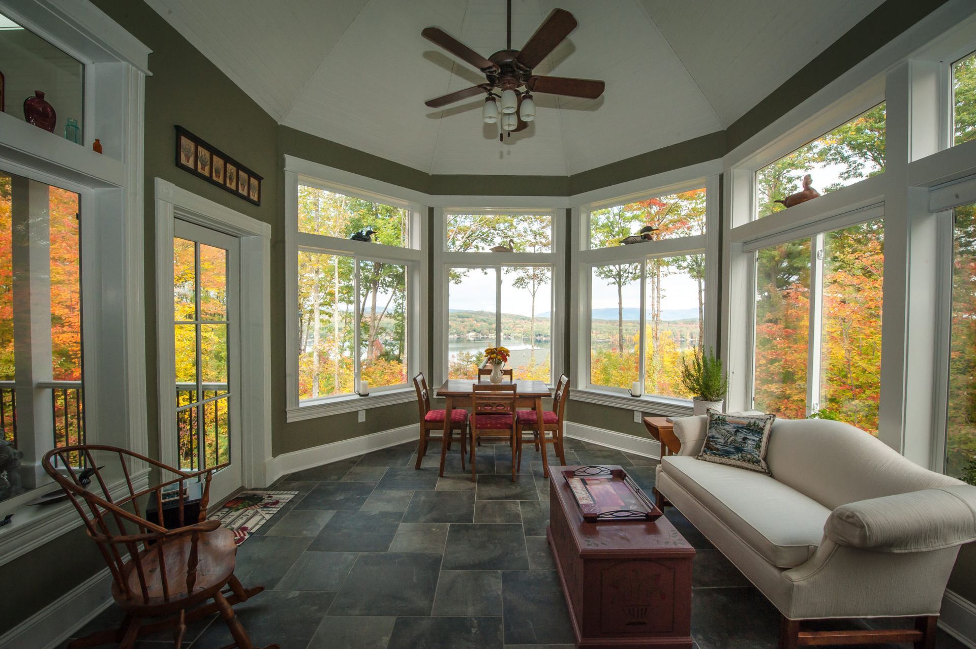 A living room filled with furniture and a ceiling fan.