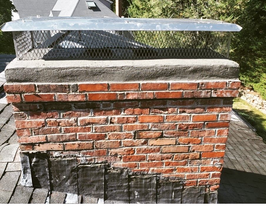 A brick chimney sitting on top of a roof