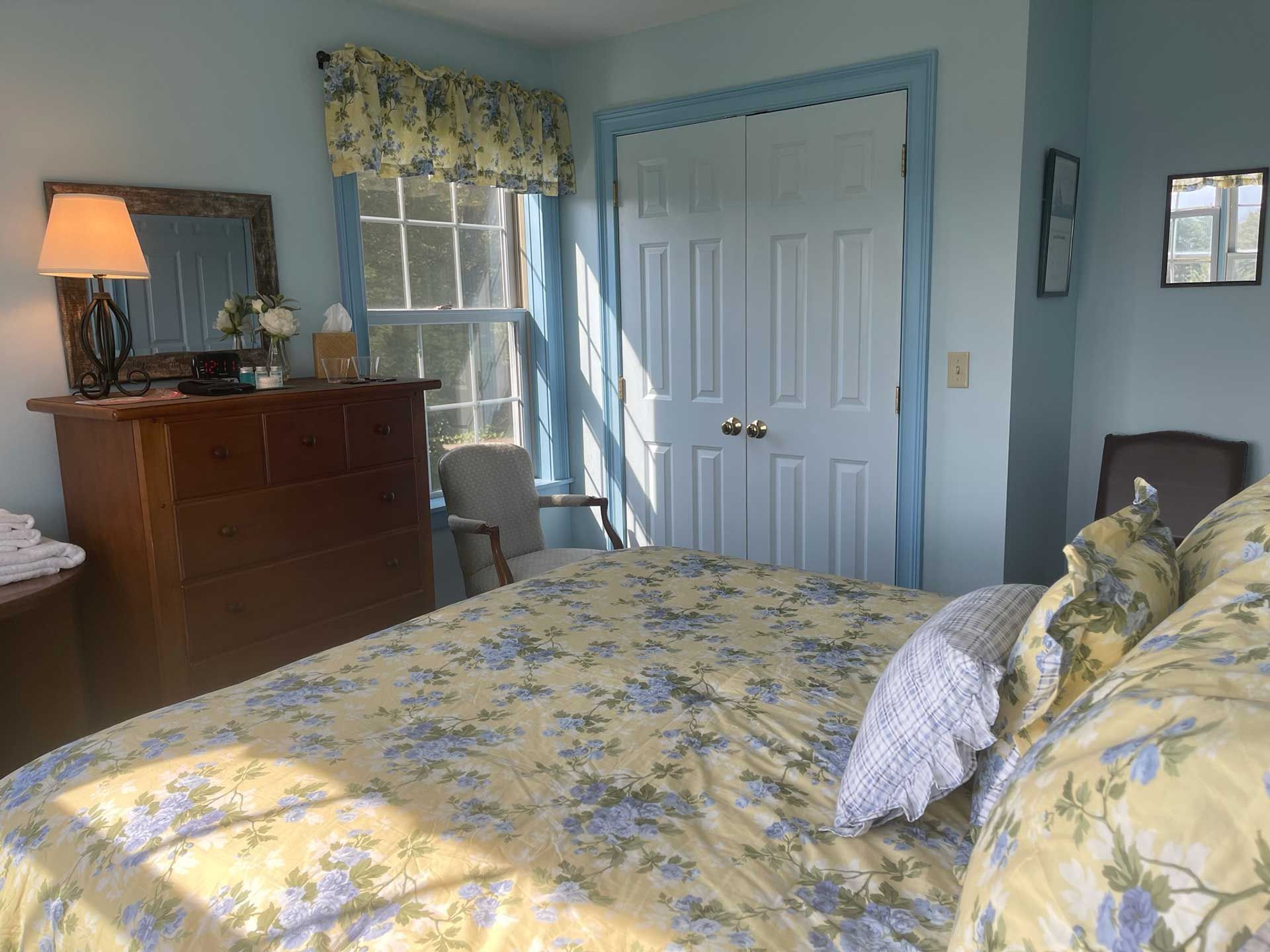 clean bedroom with a dresser and a chair