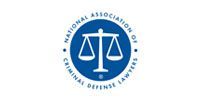 Logo for the National Association of Criminal Defense Lawyers; blue circle with scales of justice symbol.