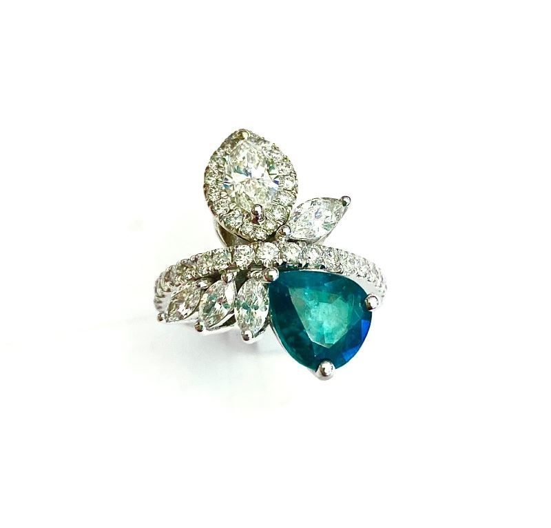 A ring with a sapphire and diamonds on a white background