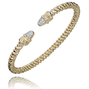 A yellow gold bracelet with diamonds on a white background