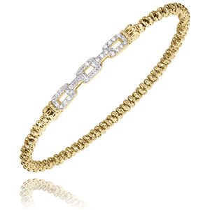 A yellow gold bracelet with diamonds on a white background