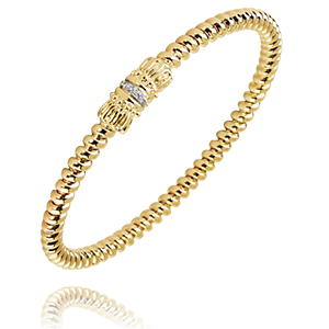 A yellow gold bracelet with diamonds on a white background