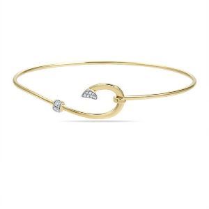 A yellow gold bangle bracelet with a crescent moon and diamonds.