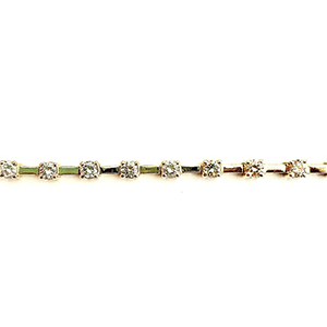 A close up of a gold bracelet with diamonds on a white background.