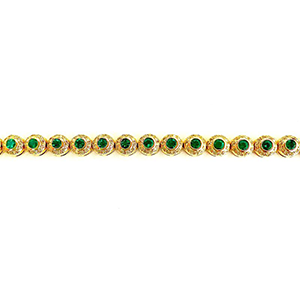 A gold tennis bracelet with emeralds and diamonds on a white background.