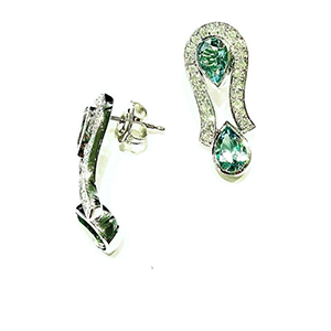A pair of earrings with green stones and diamonds on a white background