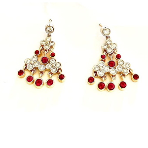 A pair of earrings with red and white stones on a white background.