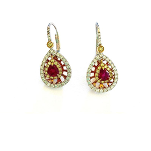 A pair of earrings with a ruby and diamonds on a white background