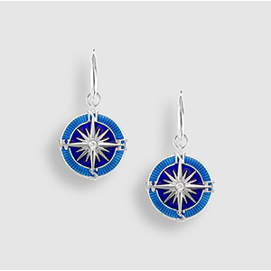 A pair of earrings with a blue compass on them