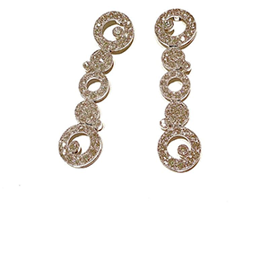 A pair of earrings with the letter g on them