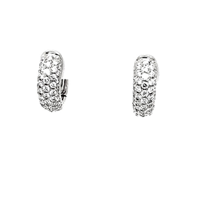 A pair of white gold hoop earrings with diamonds on a white background.