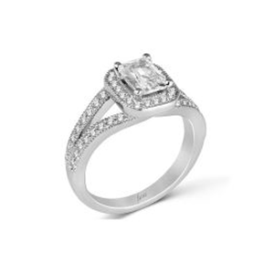 A white gold ring with an emerald cut diamond in the center